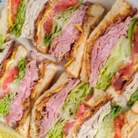 Turkey & Bacon Club Sandwich · Sliced turkey breast, crisp bacon, lettuce, tomatoes and mayo on bread.