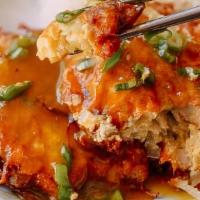 Chicken Egg Foo Young · Three omelettes with brown gravy and white rice.