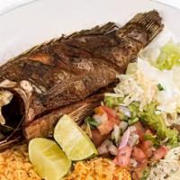 Mojarra Frita / Fried Tilapia · Served with rice , beans ,salad , and two freshly handmade tortillas.