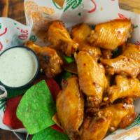 Chicken Wings · Choice of traditional bone-in wings or lightly breaded boneless wings tossed with your favor...