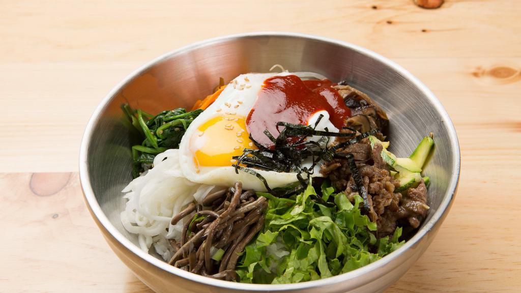 Bi Bim Bap · Assorted seasoned vegetables with choice of beef, chicken or tofu on a bed of rice with egg.