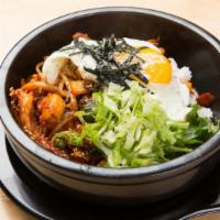 Seafood Bi Bim Bap · A combination of shrimp and squid on a bed of rice, served in a hot stone bowl with egg.