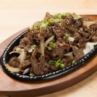 Beef Bulgogi · Thin slices of marinated beef, served on sizzling cast iron skillet.