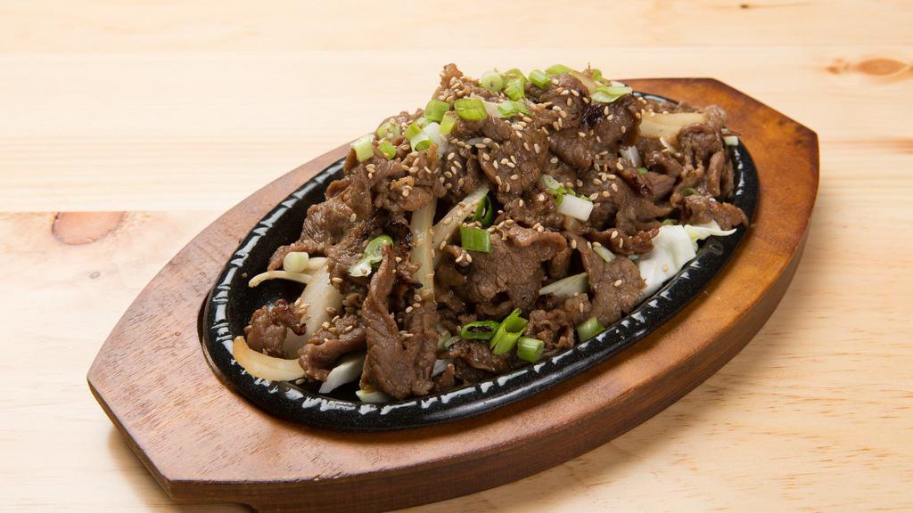 Beef Bulgogi · Thin slices of marinated beef, served on sizzling cast iron skillet.