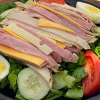 Julienne Salad · Tomatoes, cucumbers, and a boiled egg over romaine lettuce. Topped with slices of ham, turke...