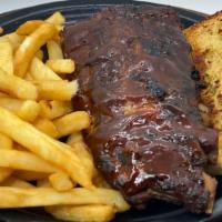 Half Slab Ribs Dinner · Pork Ribs slowly cooked to perfection and slathered in BBQ sauce with garlic bread, coleslaw...