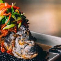 Ca Chien Sot Ca (Fried Whole Fish) · Fried seasonal  fish, charred tomato stew on Chinese forbidden rice with cilantro and banana...