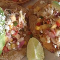 Fish Tacos · 3 corn tortillas filled with pan seared haddock, topped with avocado, cabbage mango salsa an...