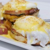 Classic Bennie · 2 poached eggs on top of canadian bacon, served on toasted english muffin, topped with homem...