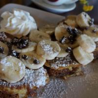 Banana Nut Bread French Toast · fresh from the bakery banana nut bread made french toast style, topped with banana slices an...
