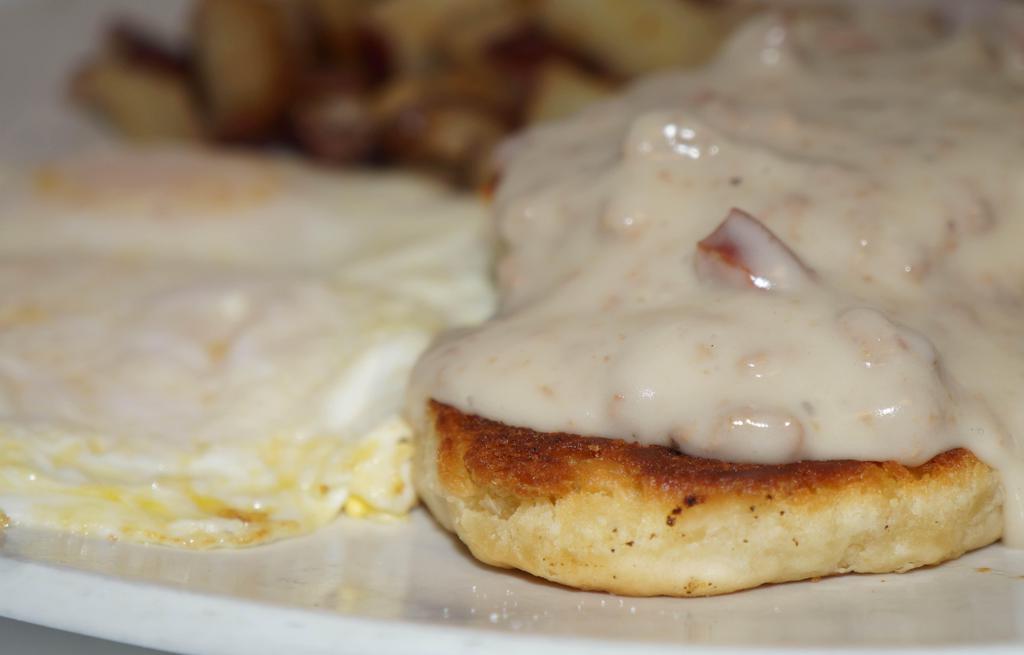 Biscuits & Gravy · 2 biscuits, cajun spiced andouille sausage gravy and two eggs any style.