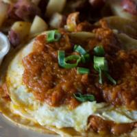 Huevos Rancheros · corn tortilla topped with cheddar jack, pinto beans with chorizo, two eggs- any style, warm ...
