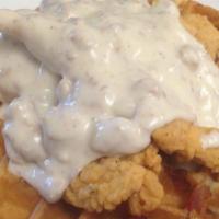 Chicken And Waffles · belgian waffle cooked with diced bacon, topped with crispy chicken tenders.