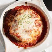 Baked Lasagna · Layered lasagna noodles, meat sauce, mozzarella cheese, ricotta cheese, and spaghetti sauce.