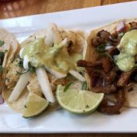 Pescado Taco · Cod breaded in a seasoned batter, cabbage, crema, agria and chipotle sauce served on flour t...