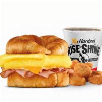 Sunrise Croissant® Combo · Choice of thinly sliced ham, crisp bacon or sausage topped with folded egg, and American che...