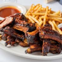 1/2 Slab Baby Back Ribs · 1/2 slab baby back pork ribs, smoked in house with hickory. Served with Gibsons Signature Ba...