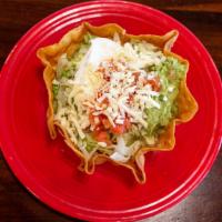 Taco Salad · Crispy flour tortilla bowl filled with your choice of ground beef or chicken topped with che...