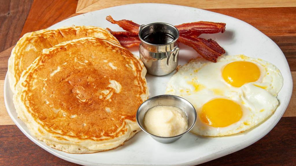 It Takes The Cake · All I ever wanted on Sunday mornings as a kid.  Here's 2 cage-free eggs, your choice of Yoder meat, and scratch-made pancakes of your choice.  Served with butter and warm syrup.