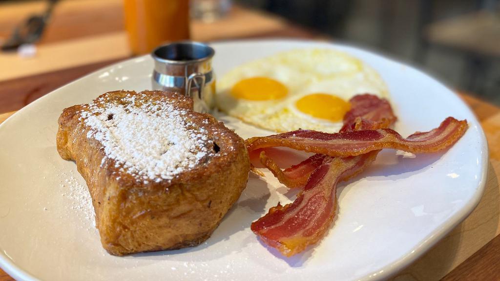Let'S Make A Toast! · Every day should begin with a toast to life!  Start yours with a soul satisfying meal of two cage-free eggs, your choice of meat and a thick slice of our cinnamon swirl french toast!