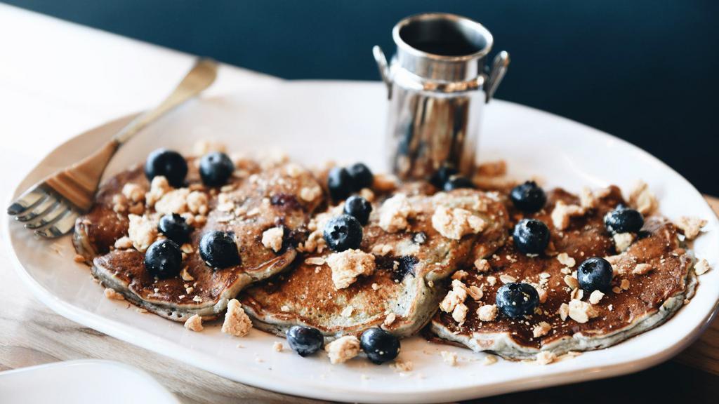 Blueberry Streusel · Loaded with so many blueberries, they are actually Blue!  Three pancakes topped with fresh blueberries and homemade streusel.  Served with warm syrup.