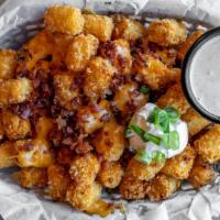 Loaded Tots · Crisp tater tots with melted Cheddar Jack cheese, bacon, green onions, sour cream and southw...