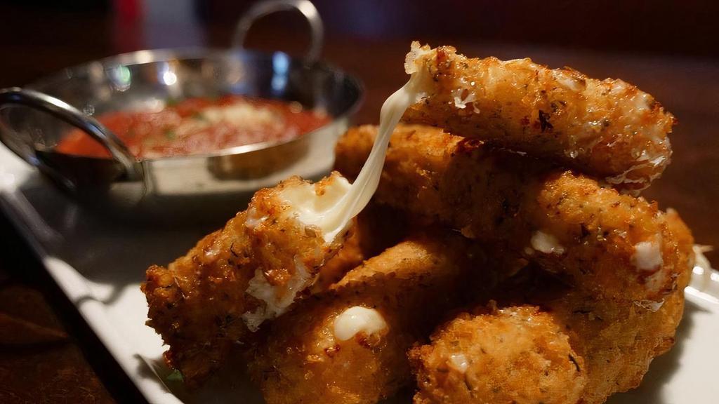 Mozzarella Sticks · Hand cut mozzarella battered and coated in herb breadcrumbs and fried golden brown served with marinara sauce.