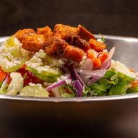 M&T Salad · Spring mix topped with carrots, cucumber, celery, tomatoes, onion and gralic croutons; garni...