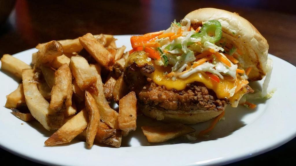 Spicy Chicken Sandwich · Fresy chicken breast marinated in buttermilk, hand breaded, fried to golden brown. Topped with cheddar cheese, fresh hand-sliced tomatoes and a bold & zesty jalapeno sauce served on a butter-toasted bun.