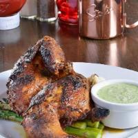 Peruvian Chicken · Whole half chicken marinated in olive oil, lime juice, garlic, cumin, paprika then oven-roas...
