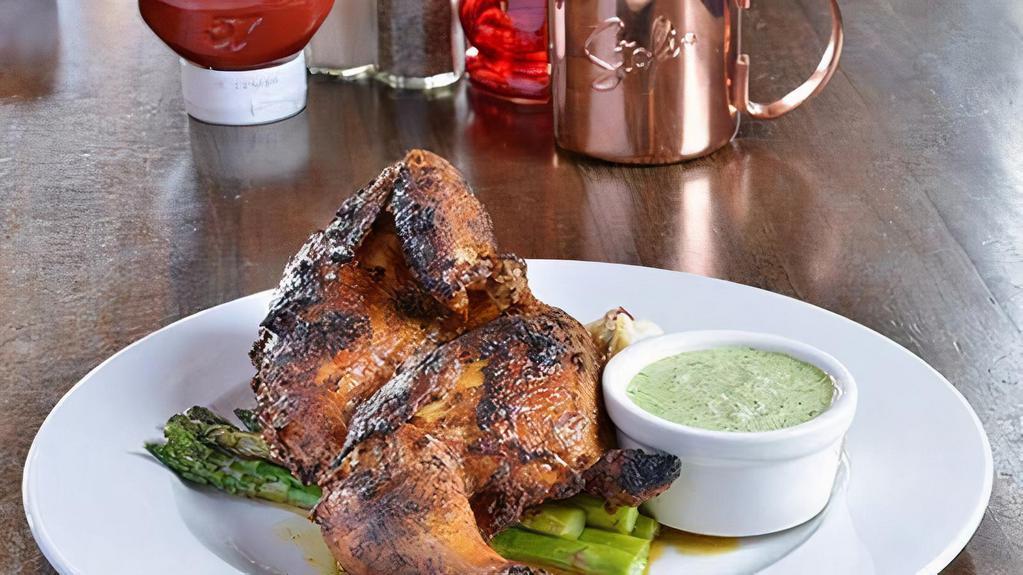 Peruvian Chicken · Whole half chicken marinated in olive oil, lime juice, garlic, cumin, paprika then oven-roasted until tender, juicy and crisp-skinned. Served with a spicy cilantro jalapeno green sauce. On a bed of house made mashed potatoes and broccoli.