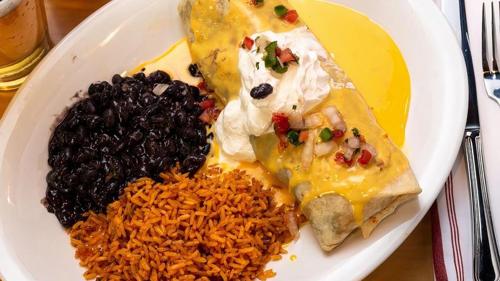 Burrito · A giant four tortilla stuffed with your choice of brisket, chicken or ground beef; black beans, rice and cheddar cheese.  Topped with our spicy chica cheese sauce and served with a side of homemade pico de gallo and sour cream.