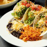 Tacos · Three soft or crispy tacos with your choice of brisket, chicken or ground beef.  Topped with...