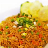 Khao Pad / Thai Fried Rice · Stir-fried rice with egg, white onions, peas, carrots, tomatoes, and green onions for garnis...