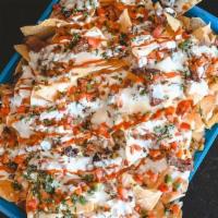 Nachos · Choice of Chopped Brisket Pulled Pork w/Tortilla Chips, Queso, Pico, Pickled Relish, Lime Cr...
