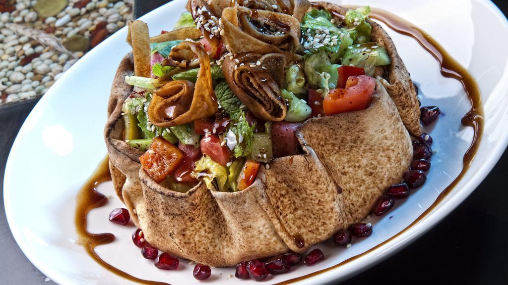 Sky Fattoush Salad · Fried pita bowl filled with lettuce, tomatoes, parsley, red cabbage, cucumber, sweet peppers, our house special dressing.