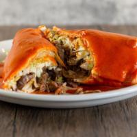 Burrito Colorado · Filled with your choice of meat, refried beans, lettuce, tomato, and cheese. Covered with me...
