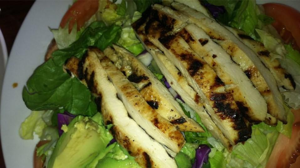Grilled Chicken Salad · Juicy chicken breast on a bed of spring mix.
Garnished with avocado and tomato.