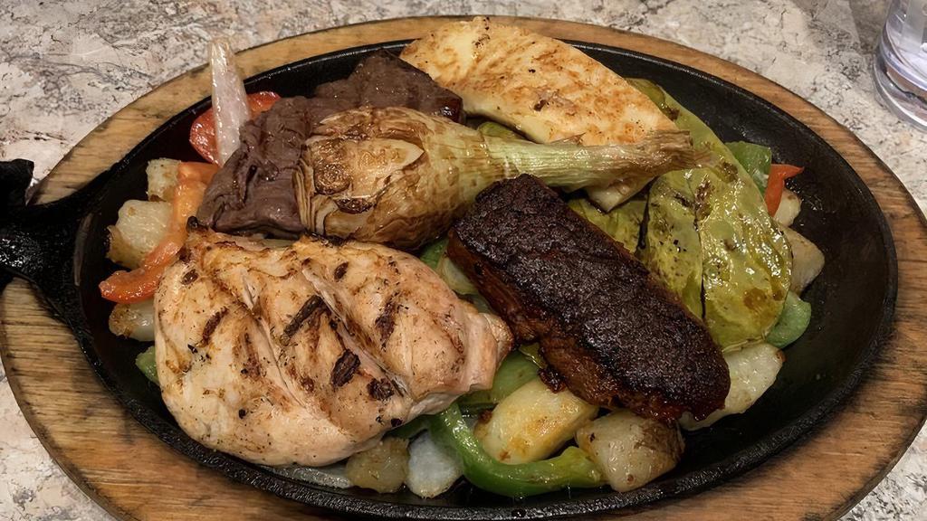 Parrillada
 · The ultimate skillet. A combination of grilled steak, grilled chicken breast, chorizo, and grilled crumbling cheese. Garnished with scallions and mild Mexican cactus. Served with tortillas, Spanish rice, refried beans, and guacamole.