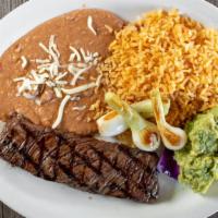 Carne Asada
 · Grilled tender steak with scallions, guacamole, spanish rice, refried beans and tortillas.