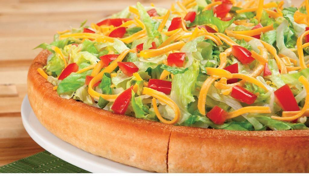 Taco Pie · This pie starts with a Spicy Taco sauce and is topped with seasoned Beef, diced Onions, Cheddar Cheese and Mozzarella Cheese, crisp Lettuce, fresh Tomatoes and extra Cheddar Cheese on top.