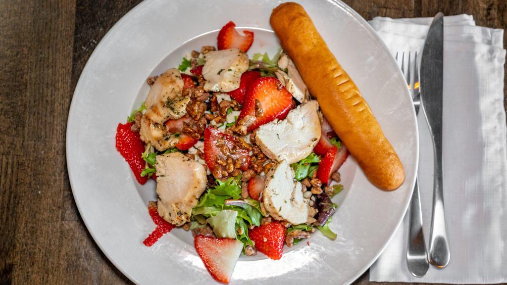 Chicken Strawberry Salad · Mixed greens, topped with grilled chicken, feta cheese, fresh strawberries, candied pecans and raspberry vinaigrette on the side.