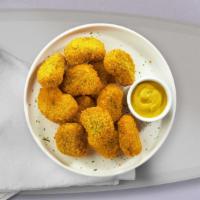 Chicken Nuggets · Bite sized nuggets of chicken breaded and fried until golden brown. (9 pieces).