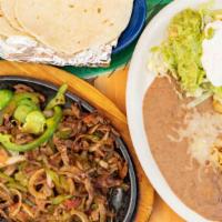 Beef Or Chicken Fajitas · Strips if beef or chicken cooked with tomatoes, onions, bell peppers, served with rice, bean...