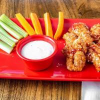 Boneless Chicken Wings · Boneless chicken wings, deep fried and coated in your choice of sauce. Includes carrots, cel...
