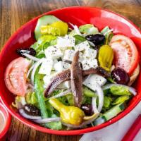 Greek Village Salad · Iceberg, romaine, tomatoes, cucumbers, green peppers, onions, Kalamata olives, feta, peppero...