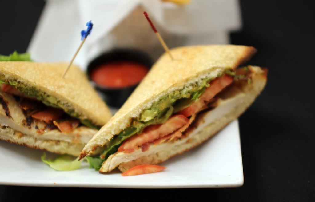 Chicken Avocado Club · Grilled chicken breast, avocado, bacon, lettuce, tomatoes, bistro sauce, mayo and provolone cheese.