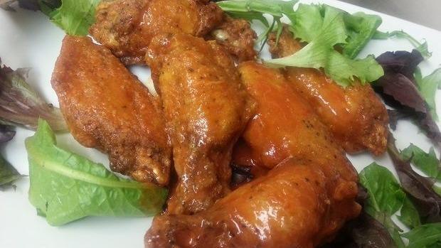 Fresh Chicken Wings · Chef favorites. Dry-rubbed fresh chicken wings. Served naked or tossed in our special sriracha blend hot sauce or BBQ sauce.