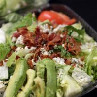 Grilled Chicken Cobb Salad · Avocado, bacon, gorgonzola, tomatoes, and egg with creamy ranch with a touch of house dressi...