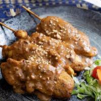 Satay (4) · Grilled chicken strips on skewers marinated with thai spices. Served with peanut and cucumbe...